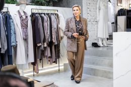 Stylish Mature Woman In Fashionable Clothing Business Outfit With Beige Trousers And Brown Tweed Blazer Standing In Female Clothing Store, Owner Of Boutique. Portrait Of Female Entrepreneur