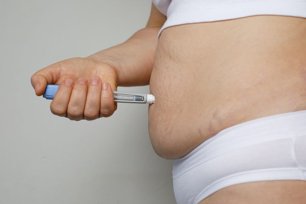 Woman Making Semaglutide Injection Pen In Her Stomach. Semaglutide Injection Diabetes Drug Being Used For Weight Loss.