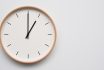 Minimalist Wooden Wall Clock On White Wooden Surface With Space For Text Time Set At 13.00/01.00