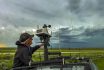 Storm Chaser Adjusts The Rooftop Weather Station On His Chase Vehicle As A Severe Storm Builds In The Background