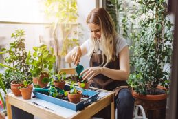 Lovely Housewife With Flower In Pot And Gardening Set