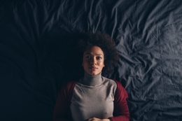 Top View Of A Beautiful Woman Lying In Bed