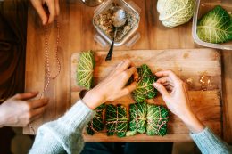 Women Making Vegetarian Savoy Cabbage Rolls For Christmas Dinner