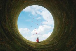 Young Boy Sitting In Fantasy Landscape