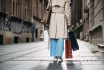 Woman Walking In City Street With Shopping Bags