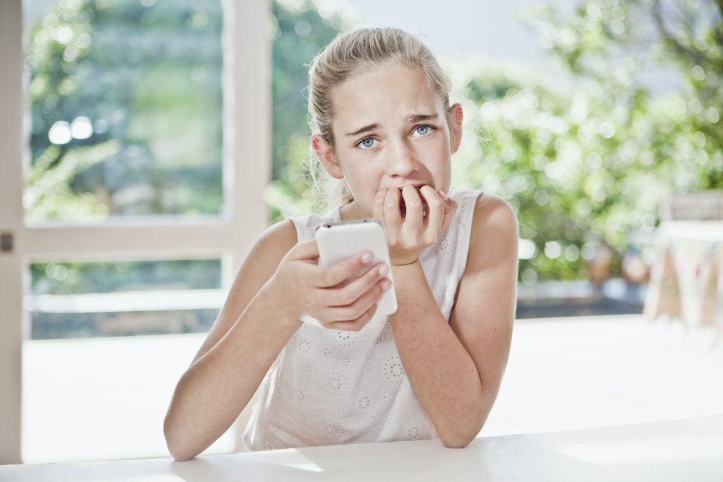 Young Girl Is Worried, Holding Phone