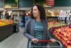 Smiling Pregnant Woman In Produce Section Of Market