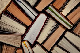 Books. Lots Of Colourful Thick Open Books Stand On A Dark Background