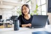 Female Professional Using Virtual Assistant At Desk