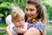 Pretty Blond Long Heared Mom And Newborn Son In Her Arms In The Summer Park.