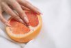 Fingers In Grapefruit On Pink Background. Sex And Masturbation Concept. Sexy Fruit Composition. Vagina Symbol.