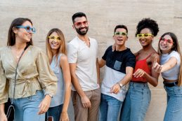 Happy People With Eyeglasses Having Fun Smiling Against A Wall