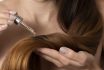 Woman Applying Hair Serum Closeup. Cosmetic Product