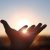 Hands Stretched Out Toward The Rising Sun At New Year's Sunrise, Brilliant Light Shining Between Fingers, Future Hope And Hope Concept