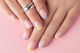 Close Up Manicured Womans Hands On Pink Background