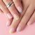 Close Up Manicured Womans Hands On Pink Background