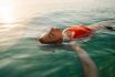Mid Adult Woman Swimming In The Calm Sea Water