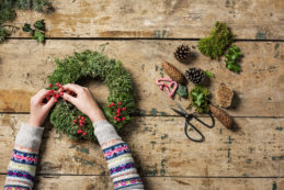 Overhead View Of Christmas Wreaths Being Made.