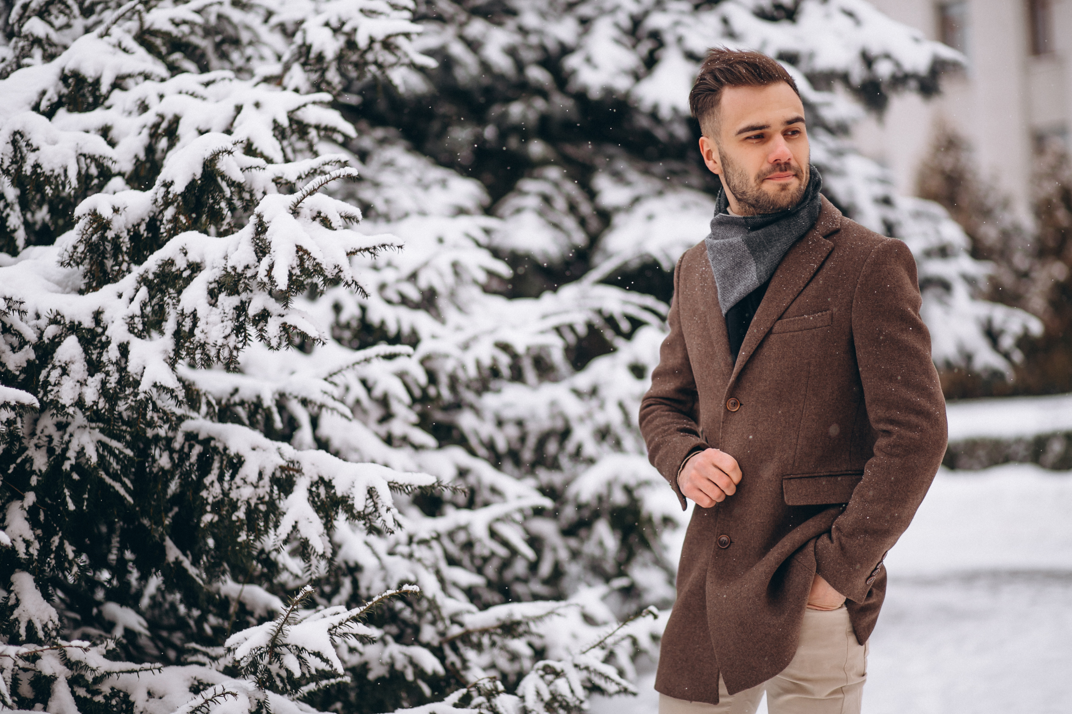 Young Handsome Man Walking In A Winter Forest