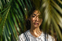 Portrait Of Beautiful Woman With Palm Tree Leaves