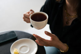 Businesswoman Holding A Cup Of Hot Tea In A Cafe